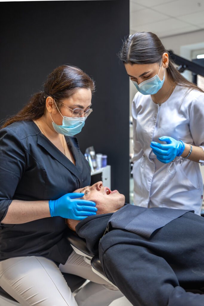 team of female dentists treating patient's teeth. visit to the dentist. dentistry. team of female dentists treating patient's teeth. visit to the dentist. dentistry.